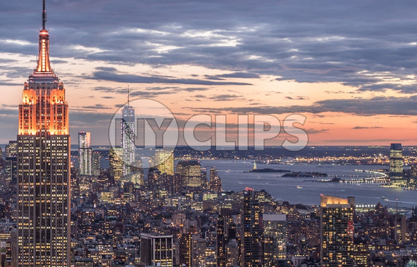 Empire State Building and Freedom Tower at sunset - famous skyscrapers in Manhattan at night with East River in distance in NYC