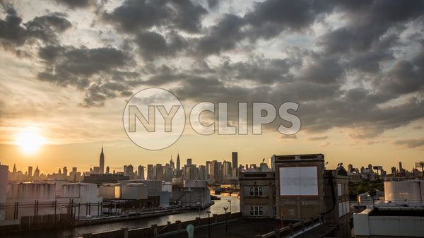 Manhattan skyline view from Brooklyn at sunset and clouds overhead in beautiful sky