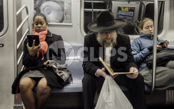 black woman and Jewish man on subway reading - diversity on public transportation in New York City NYC
