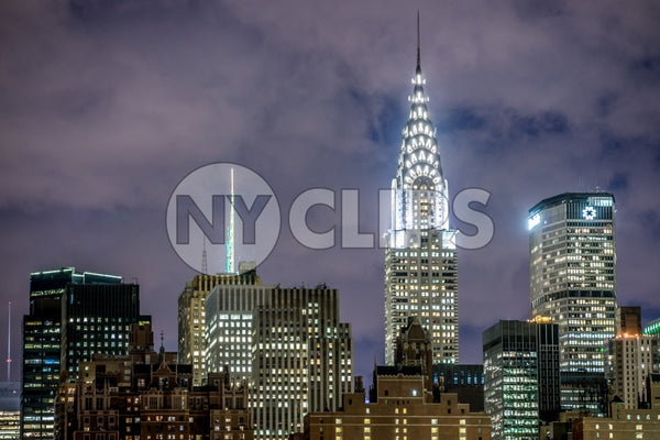 Chrysler Building and MetLife skyscraper at night with bright lights in Manhattan NYC