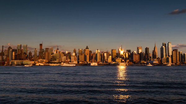 Midtown Manhattan skyline from across East River - day to night timela ...