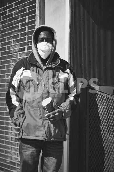 man in mask with cup in winter New York City