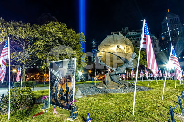 September 11th memorial painting of firefighters - heroes commemorated in Battery Park at night with American flags and 911 beams