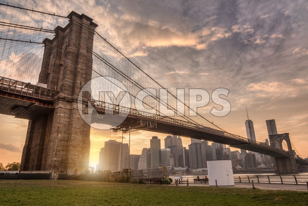 Brooklyn Bridge Park with Manhattan skyline across East River and beautiful orange sunset in NYC