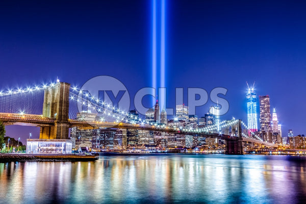 beautiful HDR night shot of Brooklyn Bridge and Manhattan skyline with city lights reflecting off East River