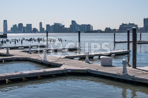 dock on East River with wood dowels and view of Queens in late afternoon day