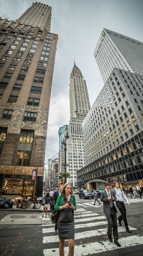 Chrysler Building towering over Midtown Manhattan - woman on