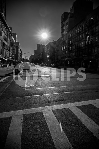 sunny day in Harlem - black and white crosswalk and bright sun shining on street