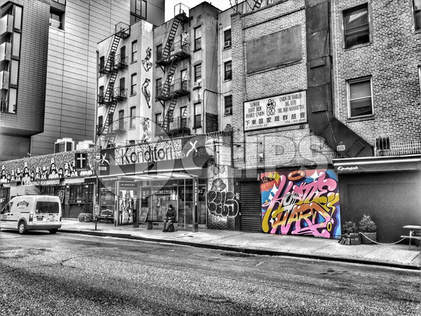 colorful graffiti piece on black and white street on Lower East Side of Manhattan in HDR