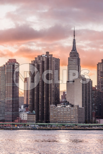 Empire State Building and skyscrapers in HDR at sunset from across East River water waves in Manhattan