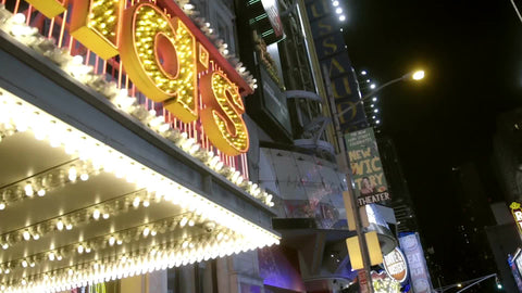 McDonalds sign at night - panning across bright letters on 42nd street off Times Square