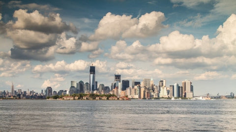 Manhattan skyline with Freedom Tower under construction and skyscrapers with blue sky and beautiful fluffy clouds