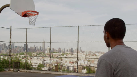 teen scoring jump shot - practicing alone on basketball court