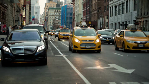 Taxis driving down Lafayette Street in early evening traffic - downtown Manhattan in NYC