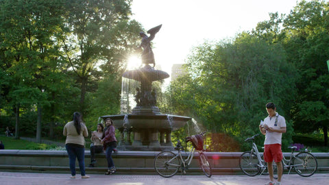 lost tourist with map - man in shorts and girls at Bethesda statue in Central Park on sunny day in summer