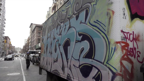 construction workers loading graffiti truck in morning in NYC