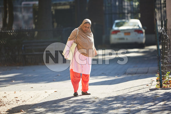 woman in shawl standing in street during day NYC
