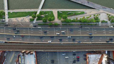 aerial of cars driving in traffic on Westside Highway by Hudson River - high up over Manhattan road in NYC