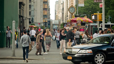 summer day in Manhattan with famous 5th Ave clock - crowded busy street
