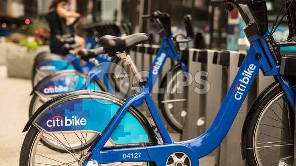 Citi Bikes parked at docking station in Manhattan on sunny summer day