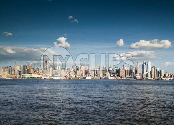 Manhattan skyline on bright sunny day from across East River water