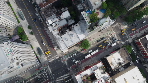 overhead of taxi cabs and cars driving in Midtown Manhattan traffic - aerial in New York City NYC