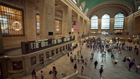 panning across interior of Grand Central Station terminal from high view in large room - summer in NYC