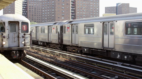 1 train arriving as another subway train leaving on elevated track in 125th street Harlem station platform