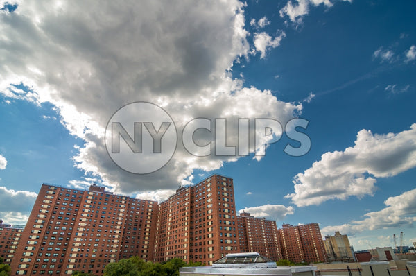 red brick buildings with blue sky and clouds on sunny summer day