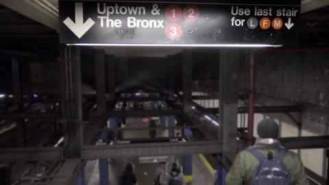 people descending downstairs to uptown 1 2 and 3 subway trains - sign for the Bronx in winter - 4K and 1080 HD in NYC