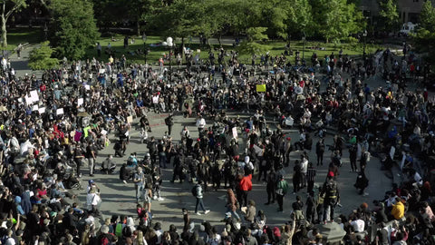 protestors with signs outside demonstration crowd NYC