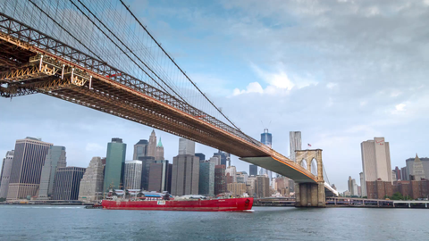 Brooklyn Bridge timelapse with Freedom Tower and Manhattan Skyline in background across East River - 4K in New York City