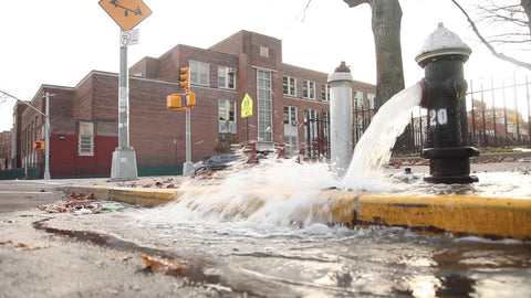 broken fire hydrant New York City street puddle water spraying NYC
