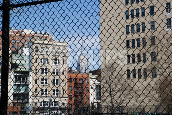 Empire State Building view through fence