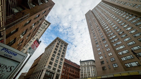 public pay phone in Downtown Manhattan - upward angle of towering buildings