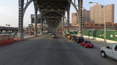moving underneath elevated subway track on 125th st in Harlem NYC
