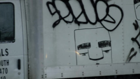 truck with graffiti driving in snow, snowing slow motion 4K