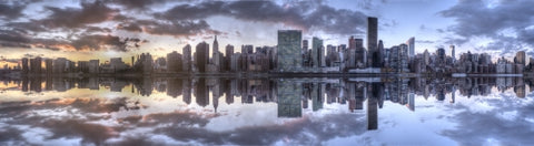 Manhattan skyline Empire State Building, United Nations sunset on East River water with sky and clouds