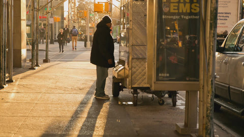 man coughing in winter at food cart in early morning New York City NYC 4K
