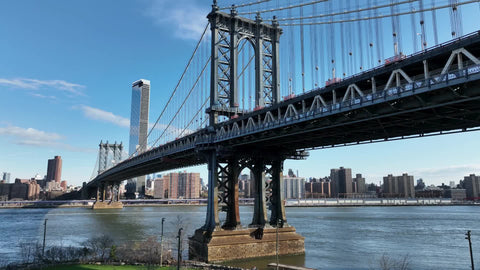 aerial flying over Manhattan Bridge to skyline buildings New York City