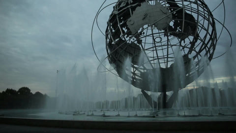 globe sculpture in Flushing Meadows Corona Park Queens NYC - water spraying from fountain in early evening