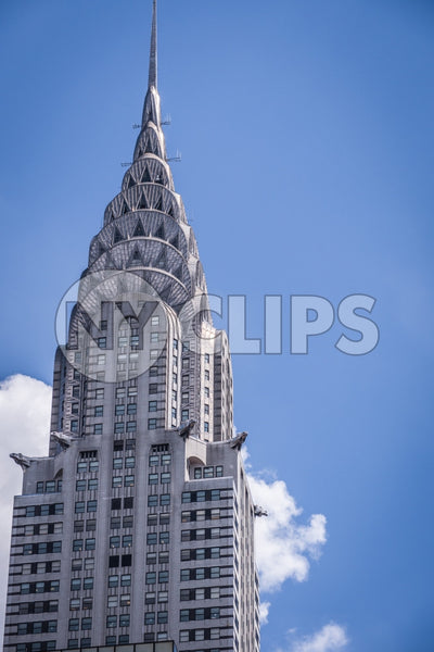 close-up of Chrysler Building famous Art Deco style skyscraper during day with blue sky in Manhattan NYC