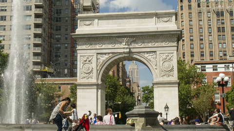 pulling back from Washington Square Park fountain and famous arch - 4K timelapse in Manhattan NYC