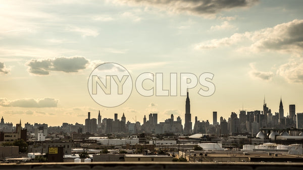 Manhattan skyline silhouette with Empire State Building view from Brooklyn in early evening sunset