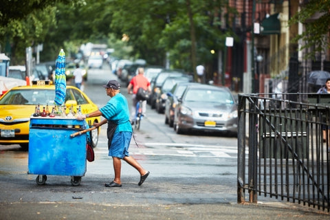 man pushing icy cart in summer New York City