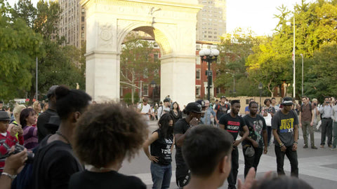break dancing in Washington Square Park summer breakdancer spinning on hands slow motion 4K NYC