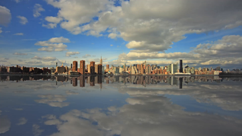 amazing artificial reflection of Manhattan skyline in river water - timelapse during the day - skyscrapers in 4K
