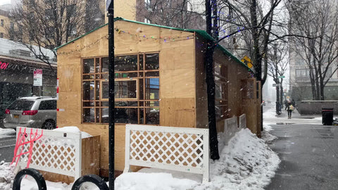 outdoor dining enclosure for restaurant in winter blizzard snowing in Manhattan New York City NYC