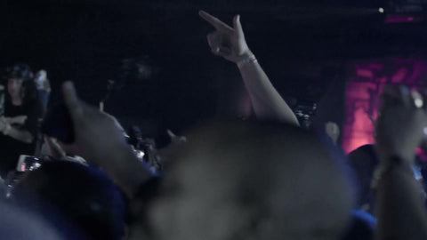 hands up in the air at hip hop rap show - close-up of smartphones and cameras