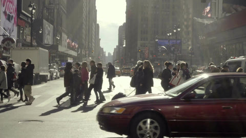 crowded crosswalk - people crossing busy street and cars, taxi cab driving across intersection - winter or fall in Midtown Manhattan New York City NYC 1080 HD